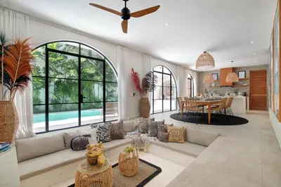 a living room with a couch and a table at Villa Sugi Umalas in Canggu