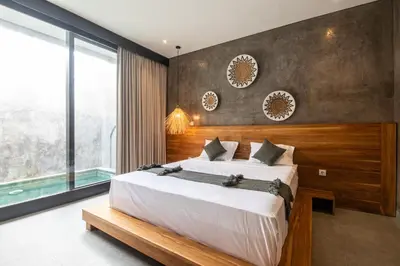 a bedroom with a large bed and a large window at Minimalist Villa with Pool #Nico1 in Canggu