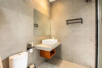 a bathroom with a sink and a toilet at Minimalist Villa with Pool #Nico1 in Canggu