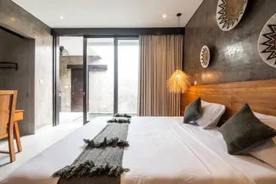 a bedroom with a large white bed with a wooden headboard at Minimalist Villa with Pool #Nico1 in Canggu