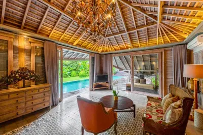 a living room with a wooden ceiling and a table at Janya 3 BR Private Pool Villa ZN158 in Canggu