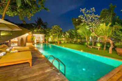 a swimming pool in a backyard with a wooden deck at Janya 3 BR Private Pool Villa ZN158 in Canggu