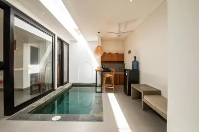 a house with a swimming pool in the middle of a room at Minimalist Villa with Pool #Lina2 in Canggu