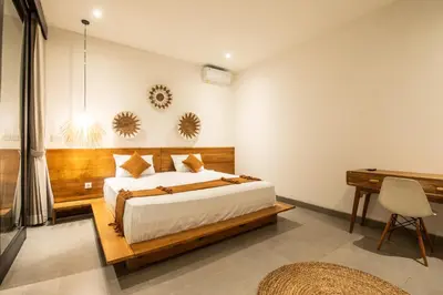 a bedroom with a large bed and a desk at Minimalist Villa with Pool #Lina2 in Canggu
