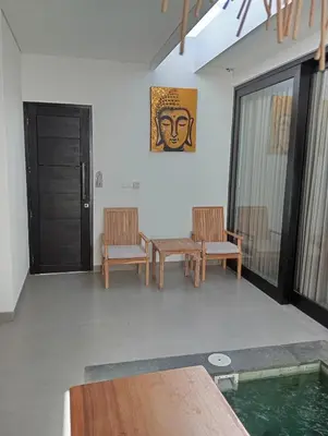 a living room with two chairs and a table at Minimalist Villa with Pool #Lina2 in Canggu