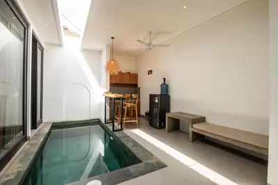 a swimming pool in the middle of a room at Minimalist Villa with Pool #Lina2 in Canggu