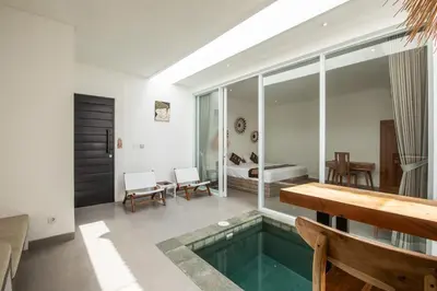 a living room with a pool in the middle of a room at Minimalist Villa with Pool #Jade3 in Canggu