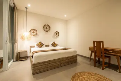 a bedroom with a bed and a desk in it at Minimalist Villa with Pool #Jade3 in Canggu