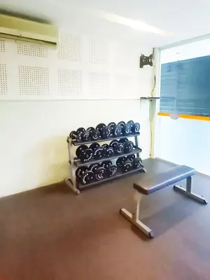 a gym room with a rack of weights at Harris Hotel & Residences Kuta in Kuta