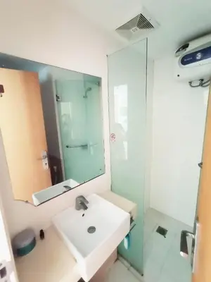a bathroom with a sink and a mirror at Harris Hotel & Residences Kuta in Kuta