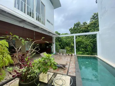 a house with a swimming pool and a patio at 3 Bedroom Calla Villa in Nusa Dua