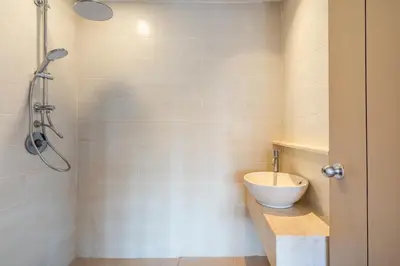 a bathroom with a sink and a shower at IRMAS Villa Bali in Seminyak