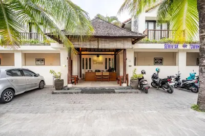 a house with two motorcycles parked in front of it at IRMAS Villa Bali in Seminyak