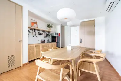 a kitchen and dining room with a wooden table and chairs at IRMAS Villa Bali in Seminyak