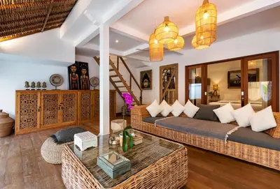 a living room with a couch and a table at Villa Waterlily by Villa Finder in Seminyak