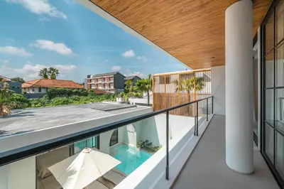 a view from the balcony of a house with a swimming pool at Villa Jenna - Exquisite 3BR Villa Close to Batu Belig Beach in Canggu