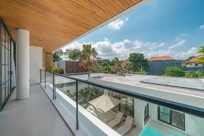 a view from the balcony of a house with a swimming pool at Villa Jenna - Exquisite 3BR Villa Close to Batu Belig Beach in Canggu
