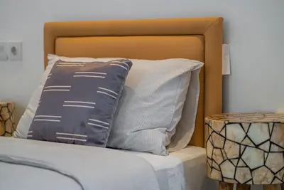a bed with two pillows on top of it at NEW! Villa Sony 1 - 3BR Villa next to Legian Beach in Seminyak