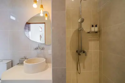 a bathroom with a shower with a toilet and a sink at NEW! Villa Sony 1 - 3BR Villa next to Legian Beach in Seminyak