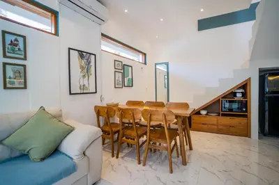 a living room with a dining room table and a couch at NEW! Villa Sony 1 - 3BR Villa next to Legian Beach in Seminyak
