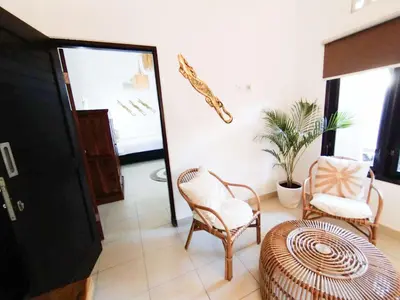 a living room with two chairs and a table at Salt Hideaway - 2 BR apartment, central Seminyak in Seminyak