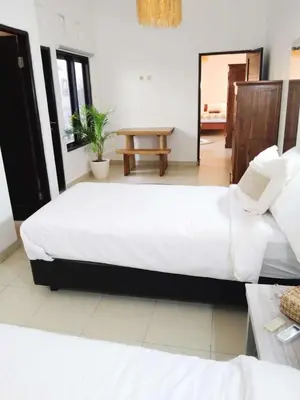 a bedroom with two large beds and a table at Salt Hideaway - 2 BR apartment, central Seminyak in Seminyak
