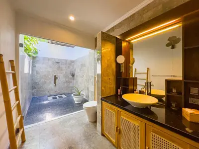 a bathroom with a sink and a toilet and a shower at Villa Blubambu in Seminyak