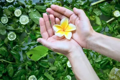 a person holding a flower in their hands at Liam 1 BR Bamboo Private Pool Villa JU63 in Seminyak