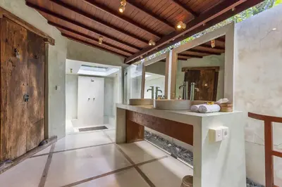 a bathroom with a sink and a mirror at Bali Villa Home in Seminyak