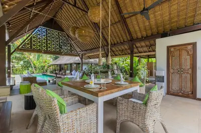 an outdoor dining area with a table and chairs at Bali Villa Home in Seminyak