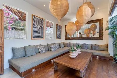 a living room with a couch and a table at Villa Elita - Modern Stylish 4BR Villa with Rooftop Lounge, 12 Minutes to the Beach in Kerobokan