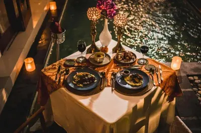 a table with plates of food and glasses of wine at Sadawira 1 BR Private Pool Villa & Bathtub ZN168 in Legian