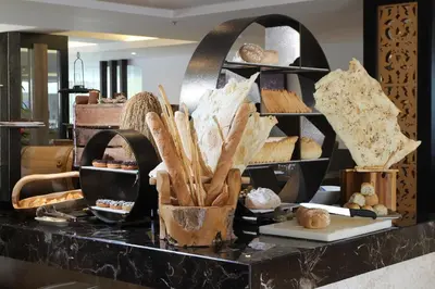a buffet with bread and pastries on a table at Sovereign Bali Hotel in Kuta
