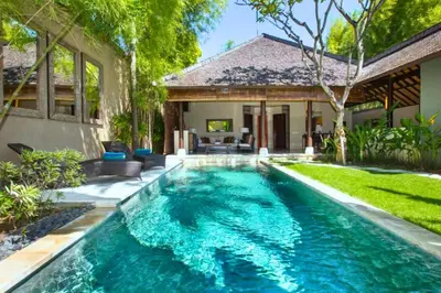 a swimming pool in the backyard of a house at Nisara 2 BR Garden Pool Villas JU67 in Seminyak