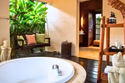 a bathroom with a bath tub in a room at Neada 4 BR Grand Pool Villa JU68 in Seminyak