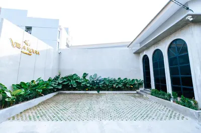 a building with a brick walkway in front of a building at Villa Koura Kuta in Kuta