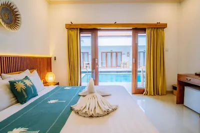 a bedroom with a bed with a starfish on it at MIMU C-O Living in Kerobokan