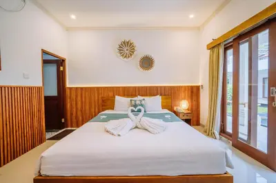 a bedroom with a bed with a towel on it at MIMU C-O Living in Kerobokan