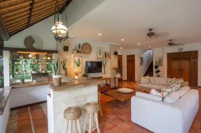 a living room with a couch and a fireplace at Villa Pande Sanur Beach Side in Sanur
