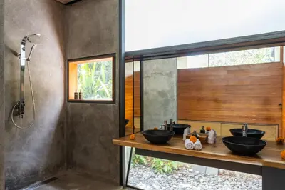 a bathroom with two sinks and a shower at Luxury Industrial Villa with Sauna and Highend Amenities in Seminyak
