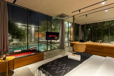 a bedroom with a tub and a tv in a room at Luxury Industrial Villa with Sauna and Highend Amenities in Seminyak