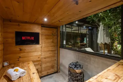 a restaurant with wooden walls and a table with towels at Luxury Industrial Villa with Sauna and Highend Amenities in Seminyak