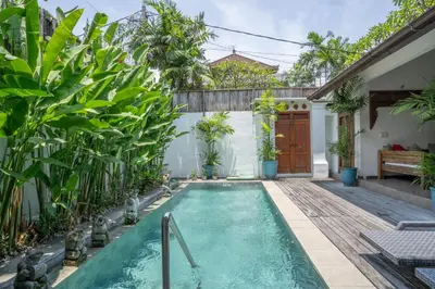 a swimming pool in the backyard of a house with plants at Villa Catalina Seminyak in Seminyak