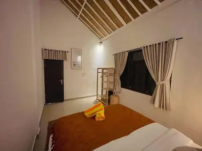a bedroom with a bed with two pillows on it at Nawa Villa private pool 3bedrooms in Seminyak