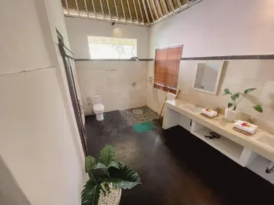 a bathroom with a sink and a toilet in it at Nawa Villa private pool 3bedrooms in Seminyak