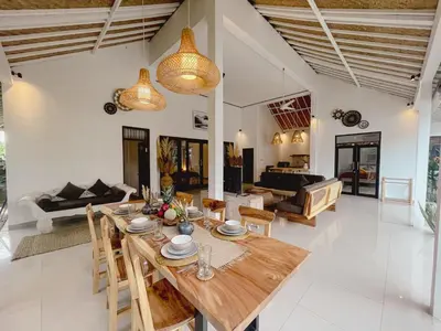 a dining room and living room with a table and chairs at Nawa Villa private pool 3bedrooms in Seminyak