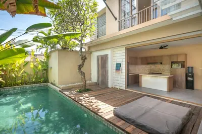 a villa with a swimming pool and a house at Villa Ewa 1 in Seminyak