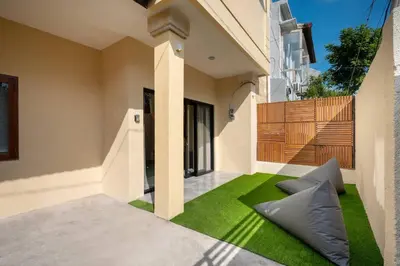 a courtyard with green grass in a house at Villa Uma Sari c9 in Seminyak