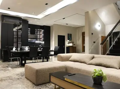a living room with a couch and a dining room at Modern Palace in Seminyak - Qmoya Villa in Seminyak