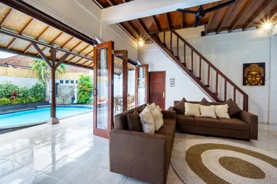 an indoor living room with a staircase and a pool at Villa Simara in Seminyak
